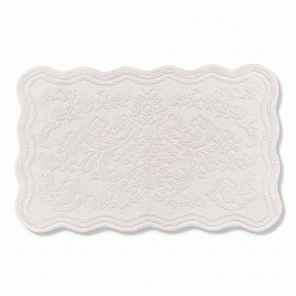 Scalloped bath mat in light grey colour, with floral texture design - made from 100% cotton.