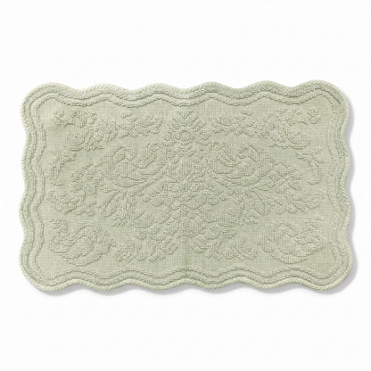 Scalloped bath mat in sage green colour, with floral texture design - made from 100% cotton.