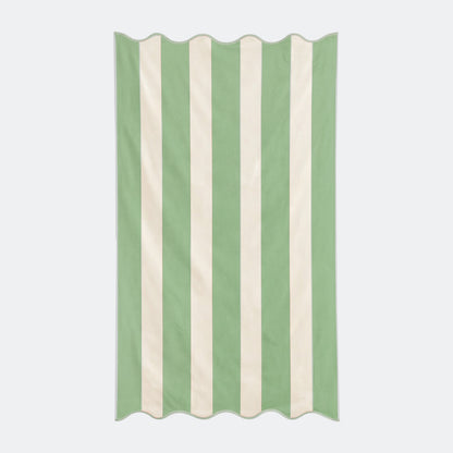 Green striped beach towel with scalloped edge, made from cotton.