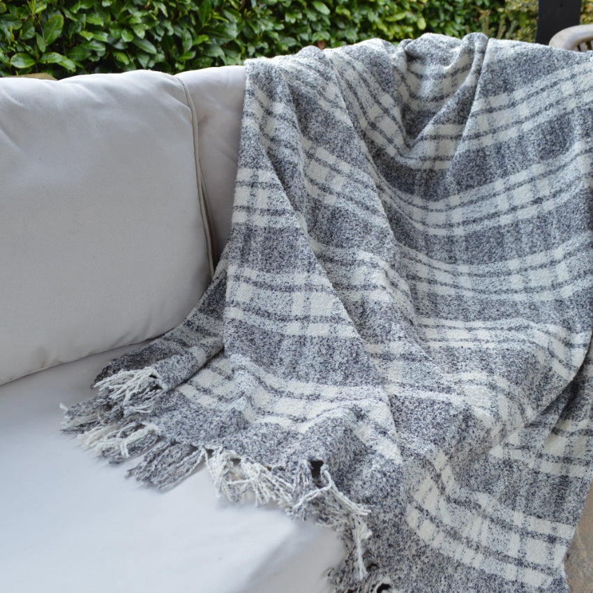 Versatile tartan check throw for the garden oh home.