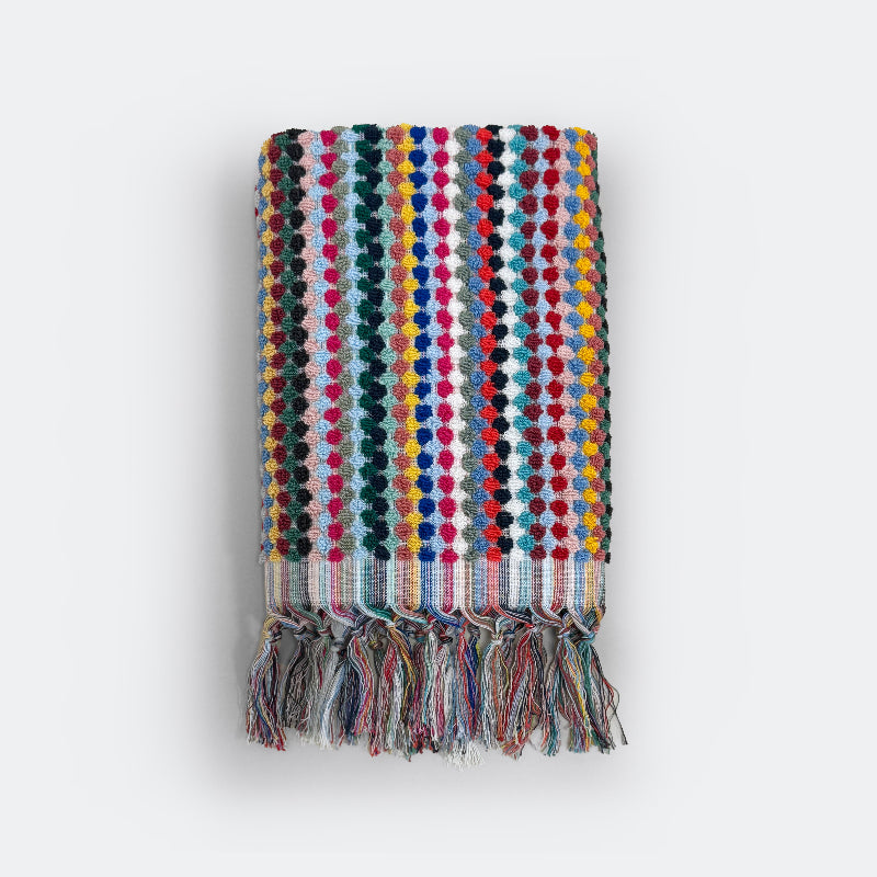 Fun patterned hand towel with tassels in textured spot design.