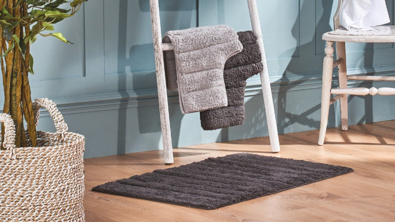 Set of bathroom mats in grey colours.