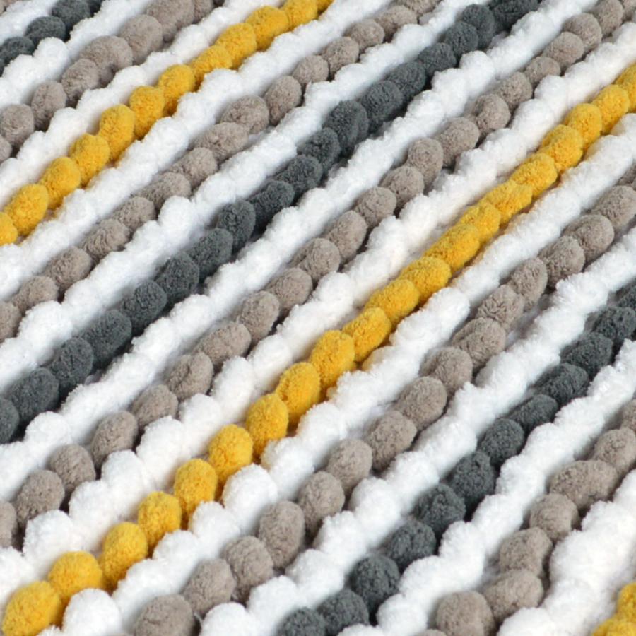 close up of a chunky bobble pedestal mat in mustard yellow