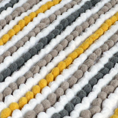 close up of a chunky bobble pedestal mat in mustard yellow