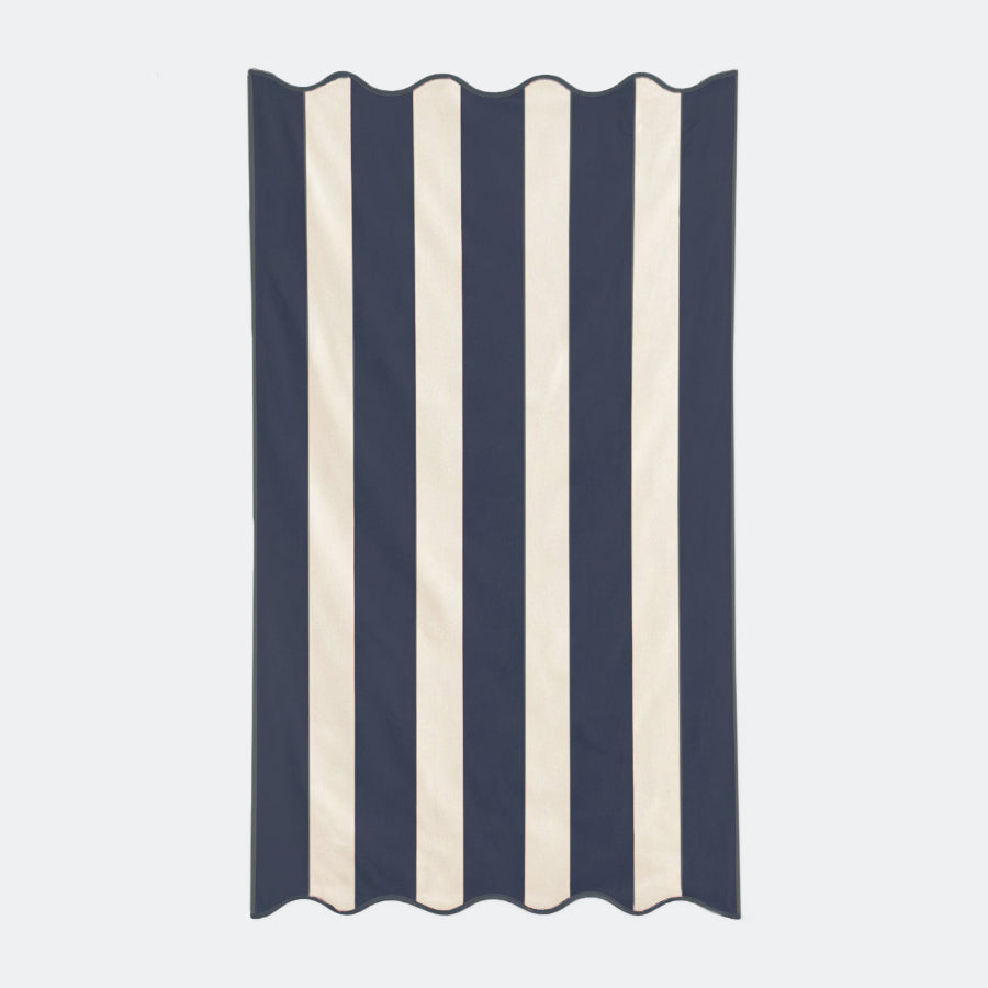 Navy blue striped beach towel with scalloped edge, made from cotton.