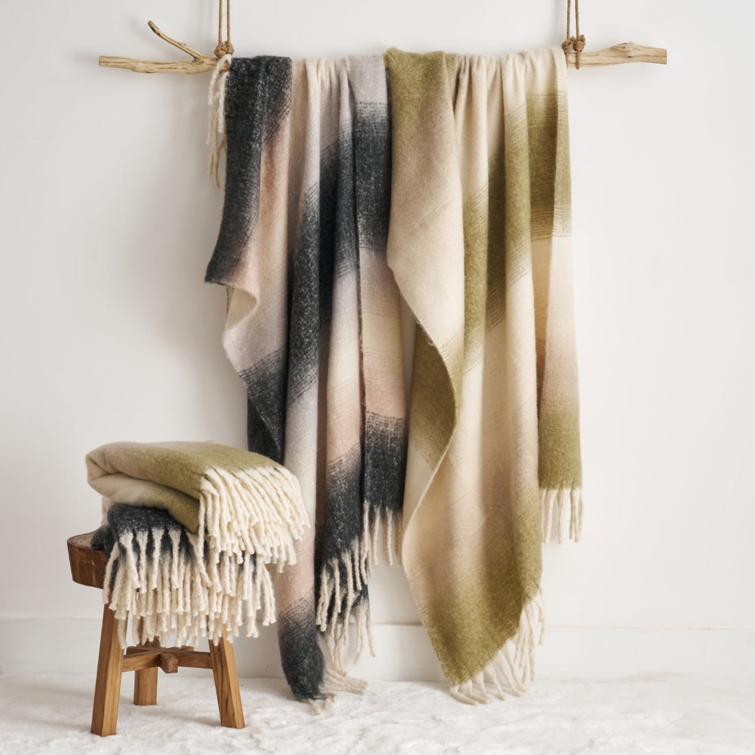 Faux mohair throw blankets in patterned ombre design.