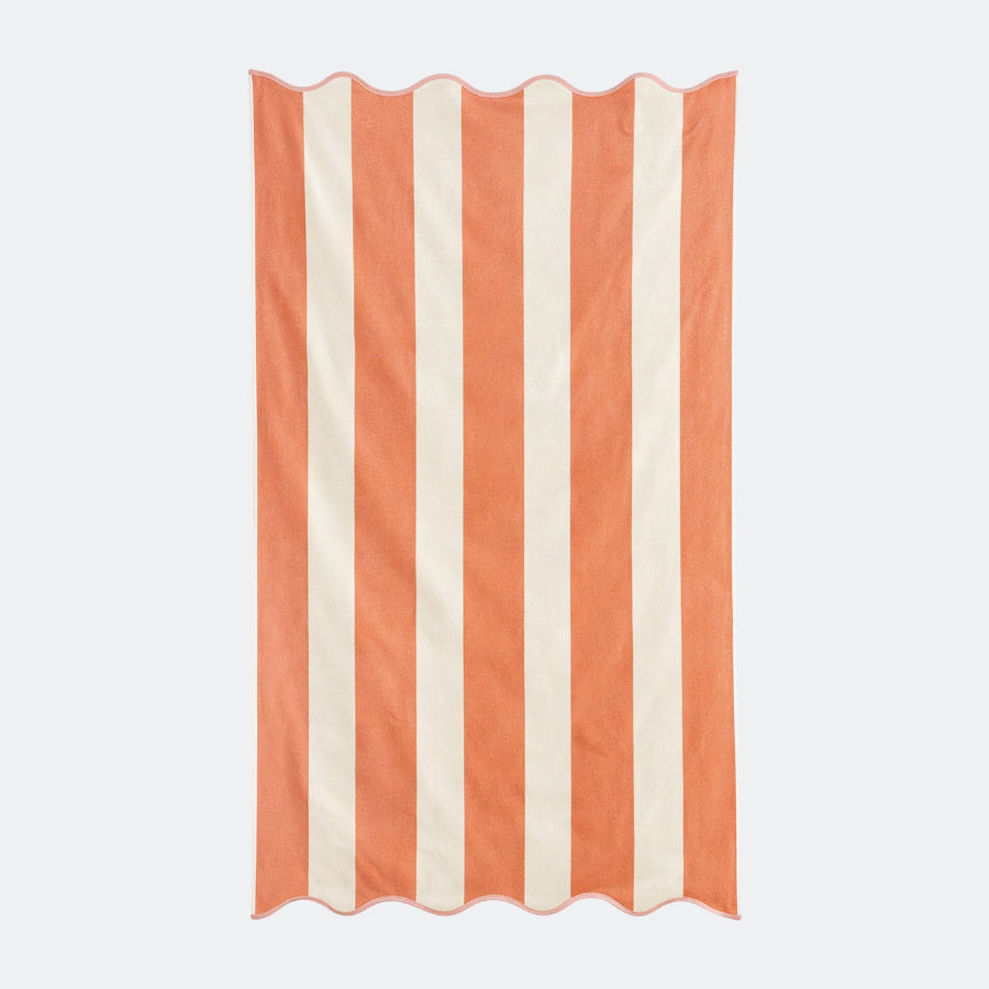 Orange striped beach towel with scalloped edge, made from cotton.