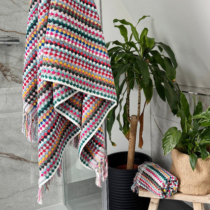 Colorful towels for the bathroom in fun pattern. Textured towels with fringe.