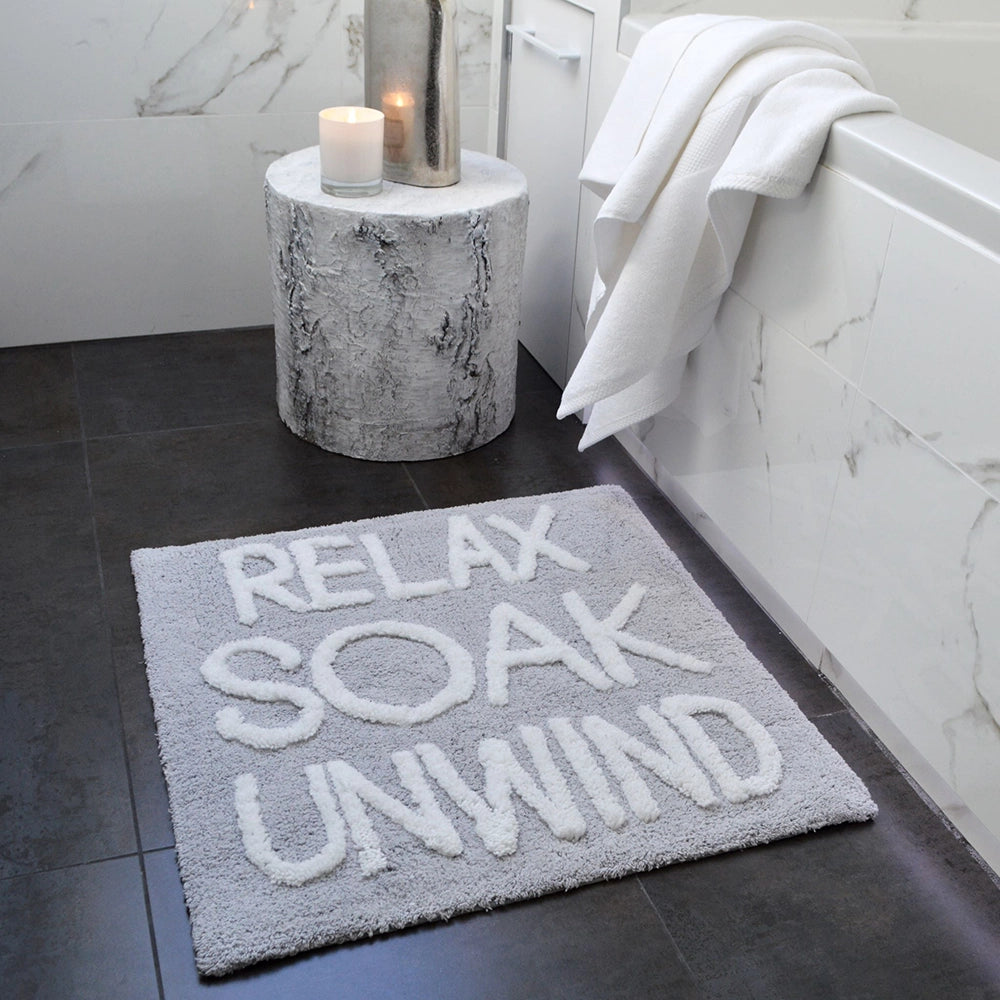 Slogan bath mat, relax soak unwind. Hand tufted bathmat