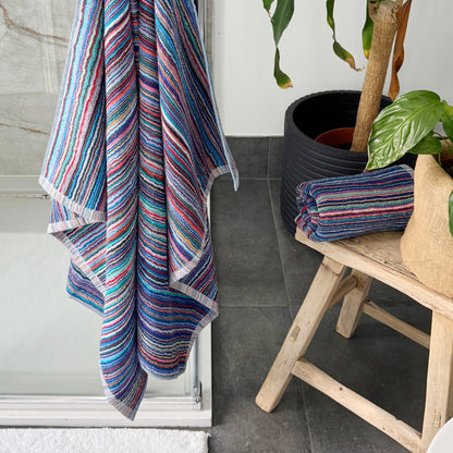 Striped bathroom towels made from sustainable recycled cotton - blue, pink, red stripes.