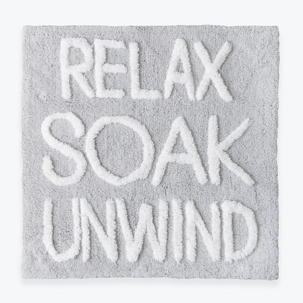 Slogan bath mat, with Relax Soak Unwind phrase