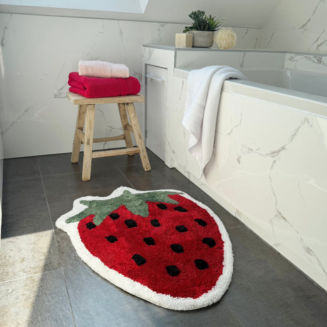 Fun shaped red strawberry rug, super soft.