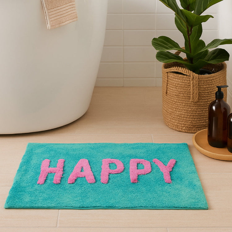 Turquoise bath mat with pink letters spelling &