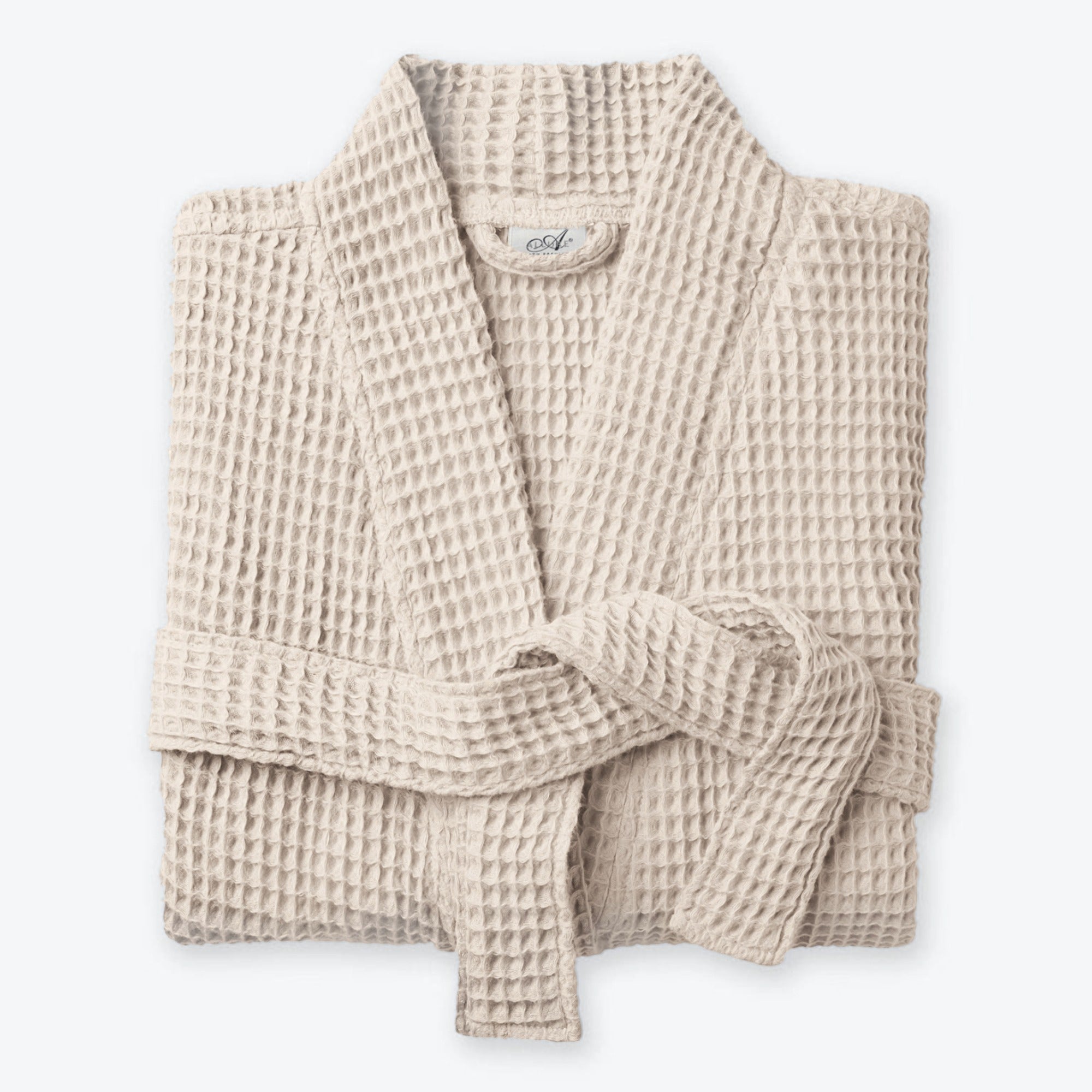Beige neutral waffle bath robe with shawl collar, pockets and belt loop fastening. 