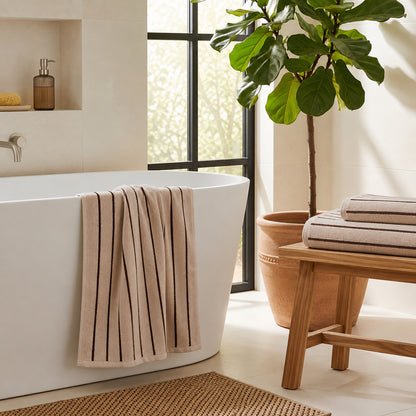 Set of striped towels for the bathroom in beige and brown colours - timeless and contemporary design.