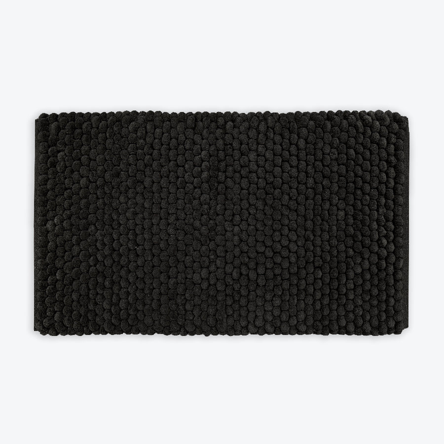 Black thick bath mat with luxury bobble texture. Super soft and absorbent washable rug.