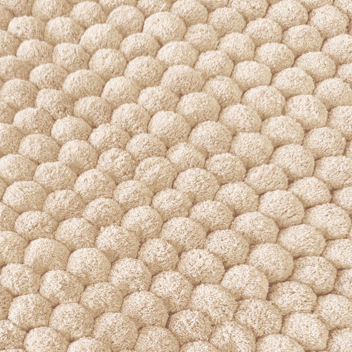 Textured bobble bath mat in neutral colour.