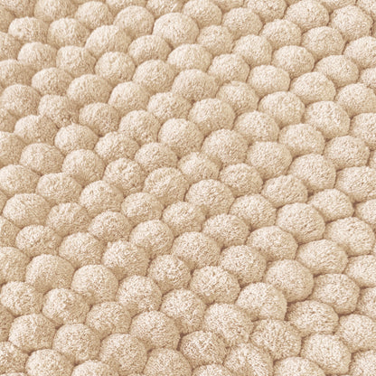 Textured bobble bath mat in neutral colour.
