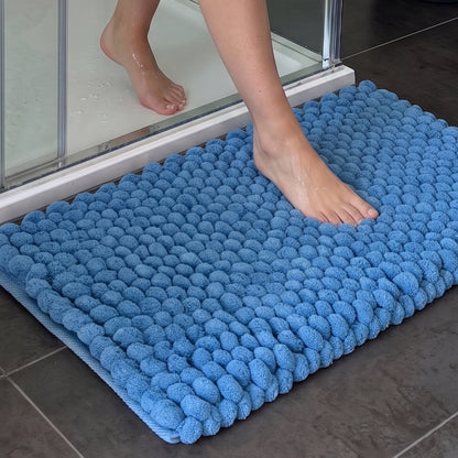 Blue thick bath mat made up of giant squishy bobbles for supreme comfort.