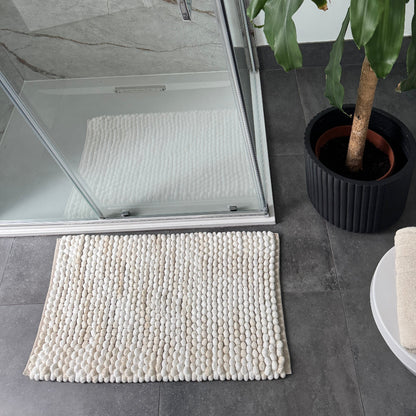 Cream and beige marble bath mat made from handwoven chunky bobbles.