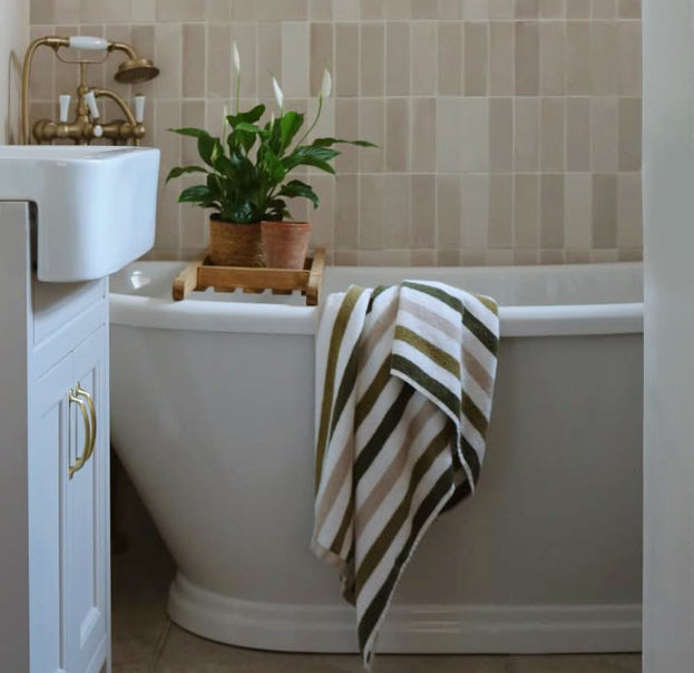 Striped bath towels in green and neutral earthy colours.