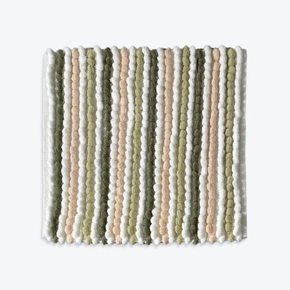 Green square bath mat, chunky plush bobbles.