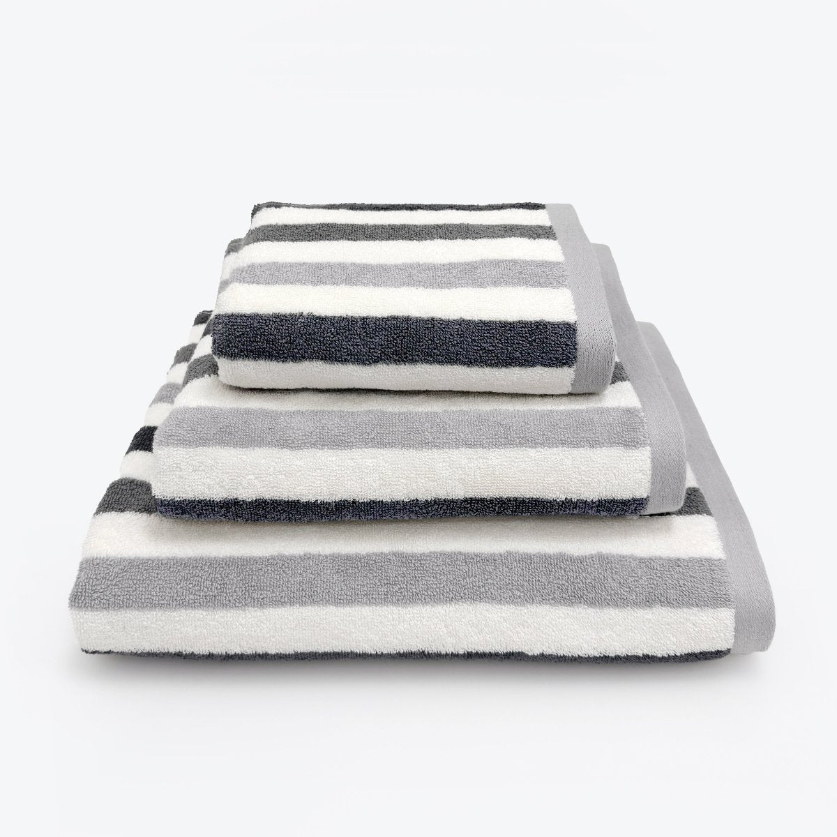 Grey striped bathroom towels set. Patterned towels in three sizes: Hand towel, bath towel and bath sheet.