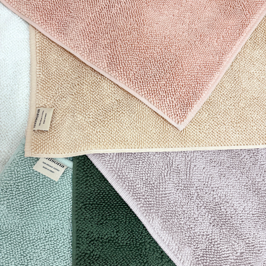 Collection of textured organic cotton loop bath mats in various colours by misona.