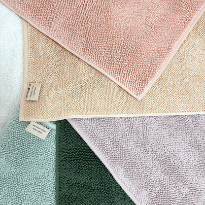 Collection of textured organic cotton loop bath mats in various colours by misona.