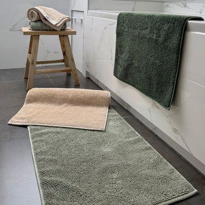 Organic cotton bath mats in neutral colours - sage green, khaki and beige.
