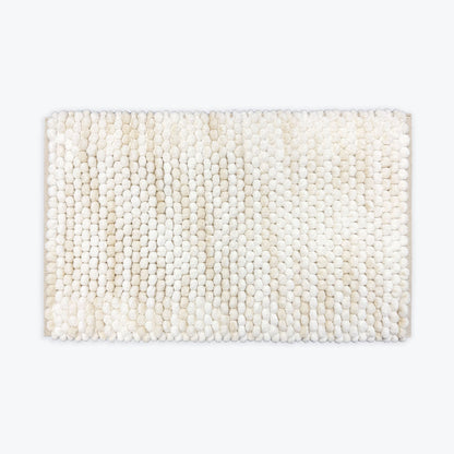White and beige bathroom mat with deep pile bobbles.