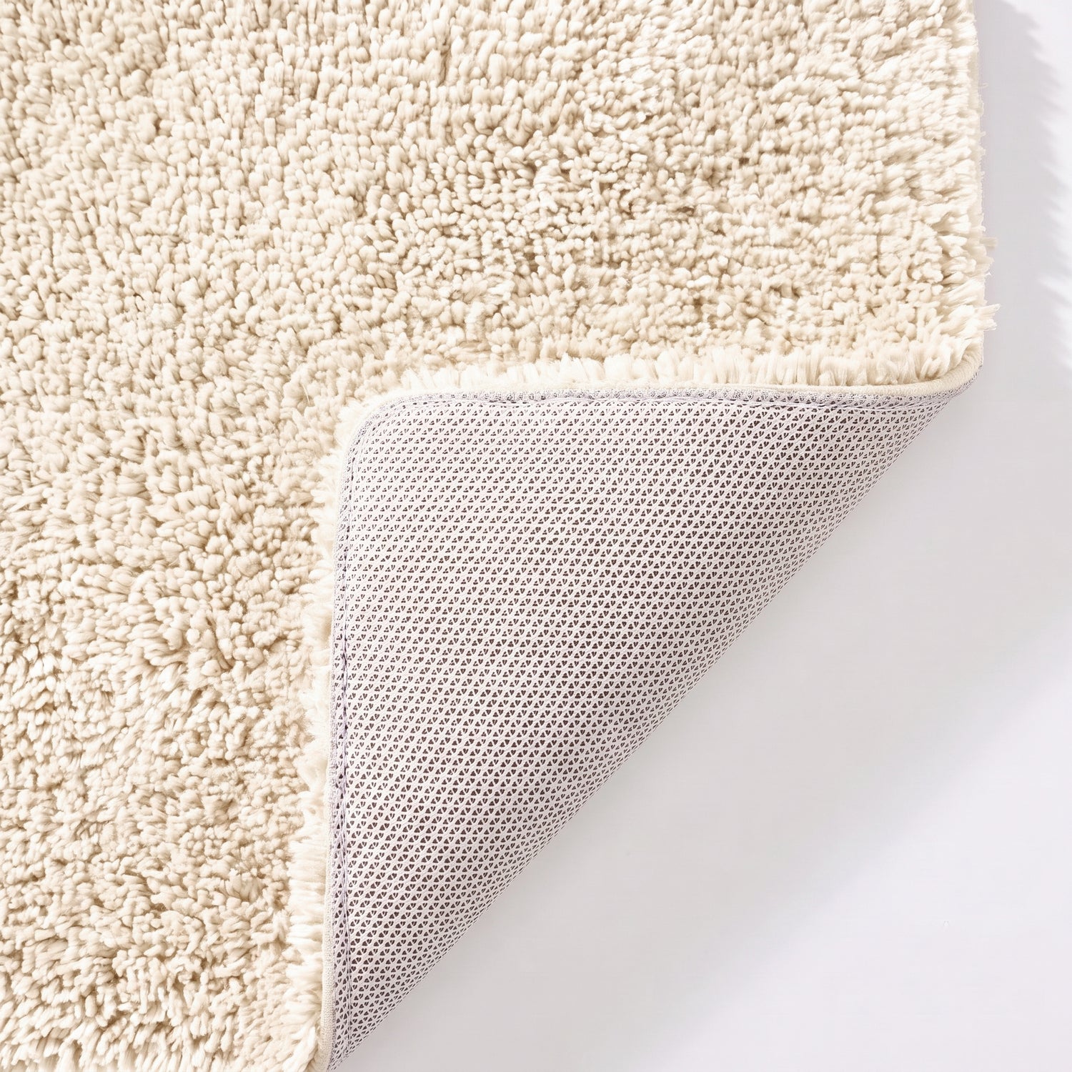 Cream non slip toilet pedestal mat with shaggy pile- 100% microfibre.
