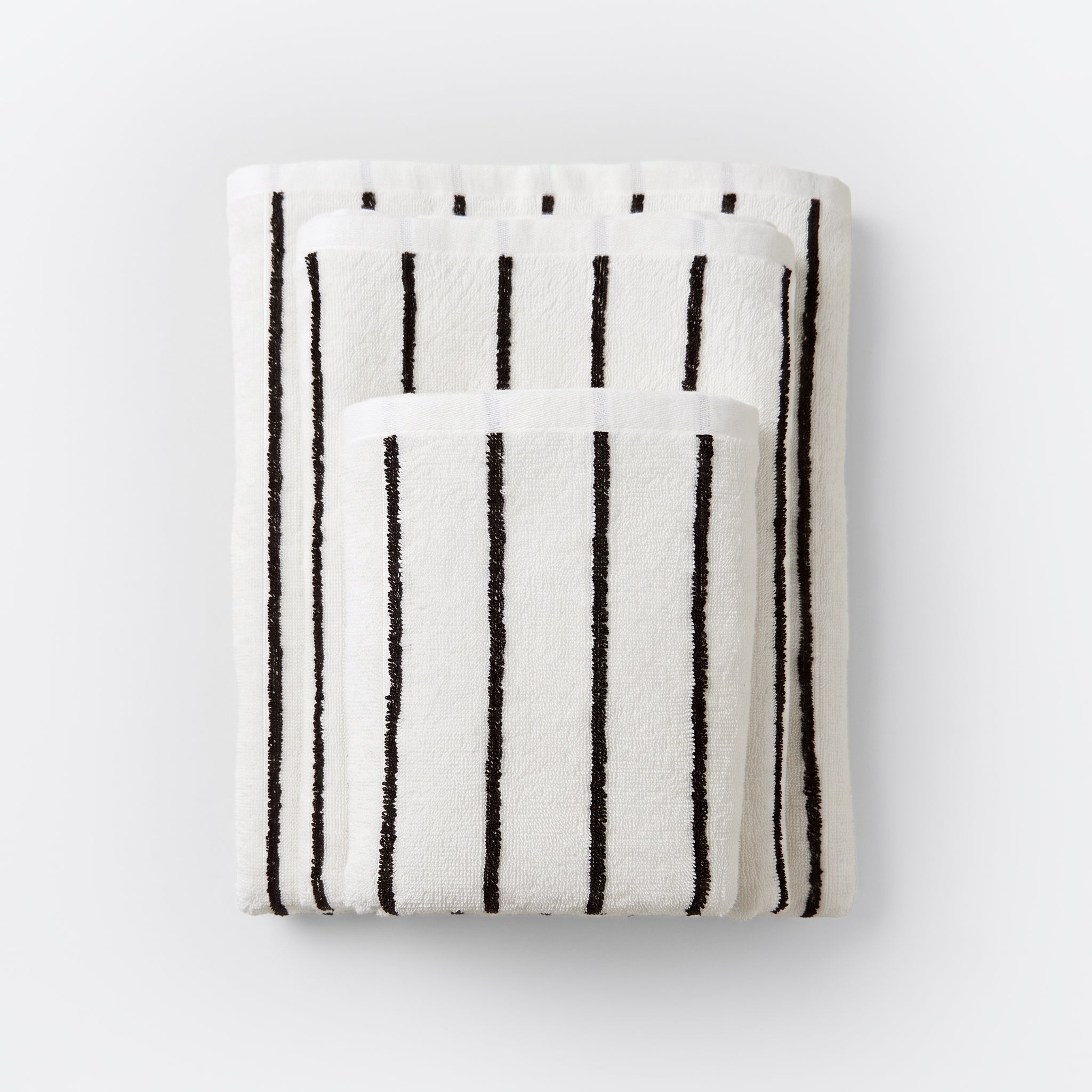 Striped bathroom towels in cream and black colours - timeless pin stripe pattern.