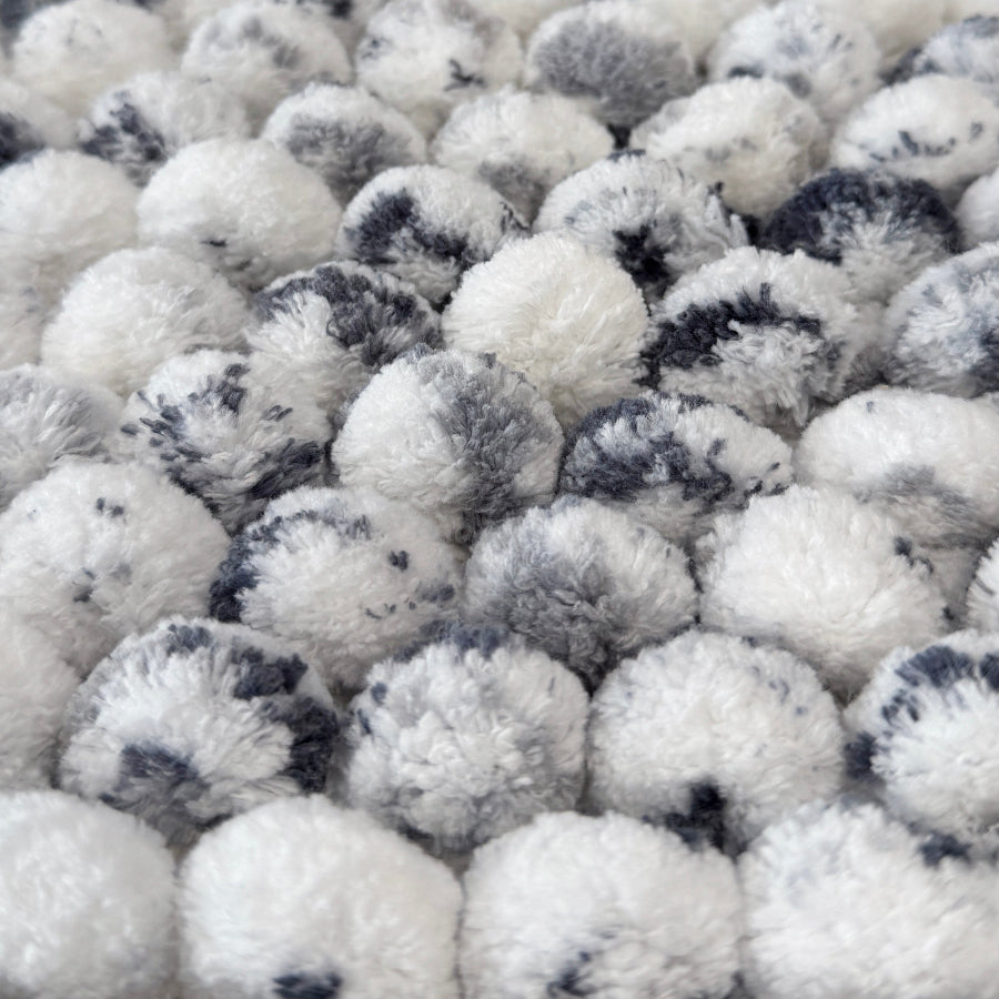 Close up of white and grey marble bath mats.