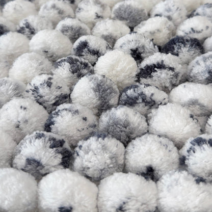 Close up of white and grey marble bath mats.