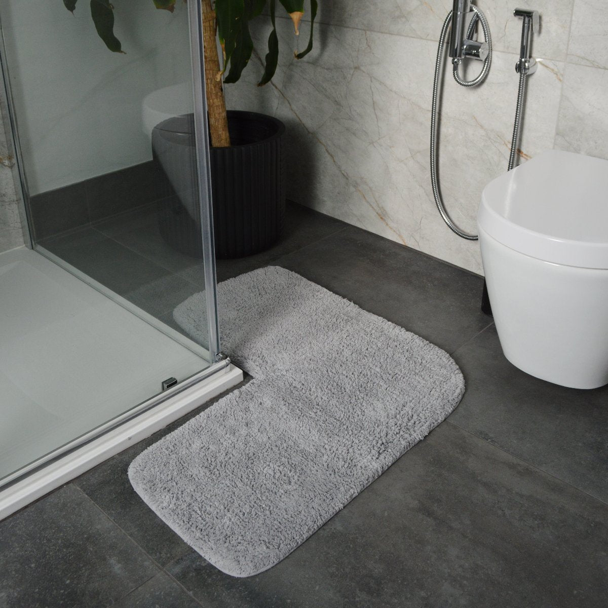 Dove grey corner shaped bath mat for shower unit