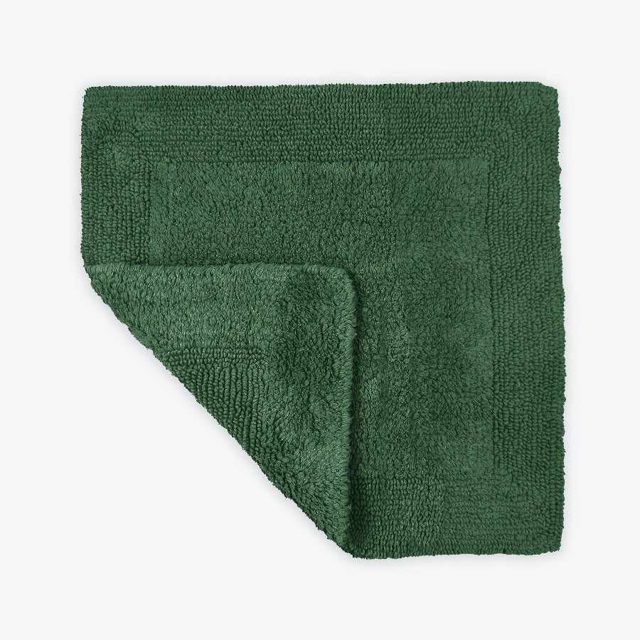 Dark green square bath mat for the bathroom. 100% cotton reversible bath rug.