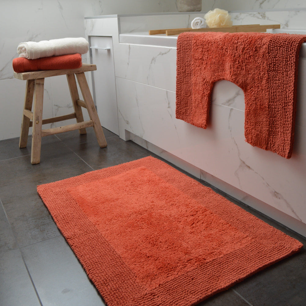 Rust orange, terracotta bath mat made from cotton with reversible design.