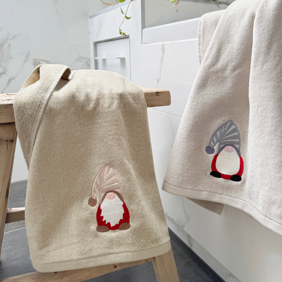 Christmas hand towels with gonk gnomes embroidered on them - beige and grey coloured towels.