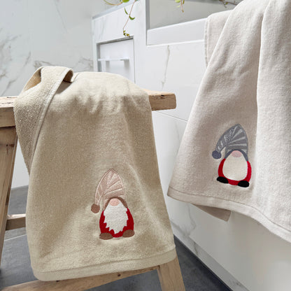 Christmas hand towels with gonk gnomes embroidered on them - beige and grey coloured towels.