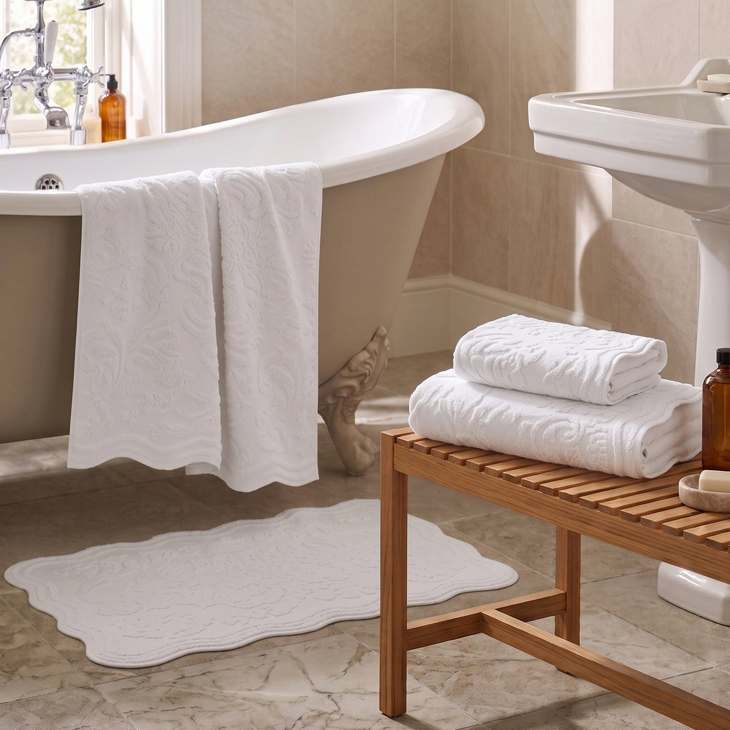 White jacquard towels for the bathroom in three sizes - hand towel, bath towel and bath sheet.