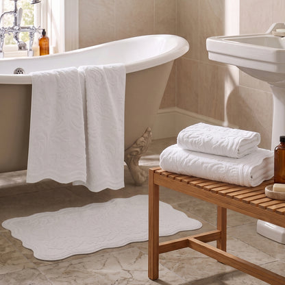 White jacquard towels for the bathroom in three sizes - hand towel, bath towel and bath sheet.
