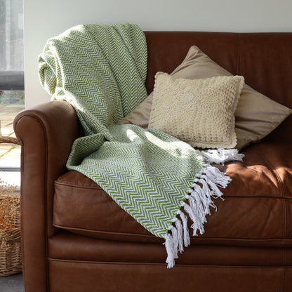 Green and white chevron blanket with tasselled fringe made from 100% cotton. 