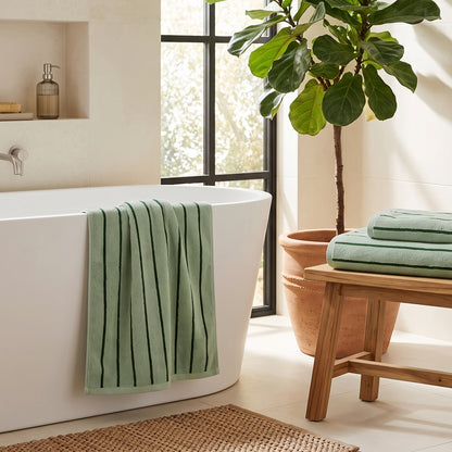 Sage green and forest green bath towels with striped pattern, for a contemporary bathroom.