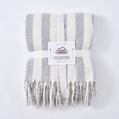 A folded grey striped throw blanket, perfect housewarming gift for a cosy monochrome home.