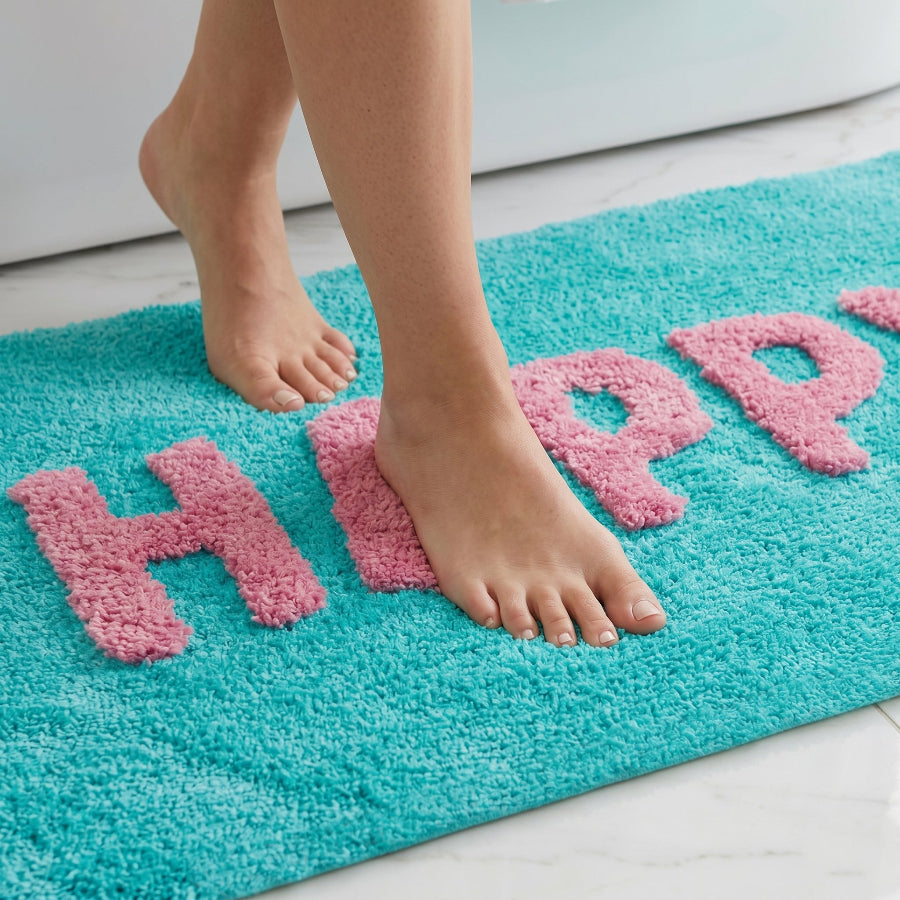 Soft, non slip bath mat with fun happy slogan design in turquoise and pink.