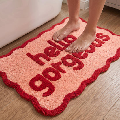 Soft slogan bath mat with hello gorgeous text and scalloped edges - pink and red bathroom accessories.