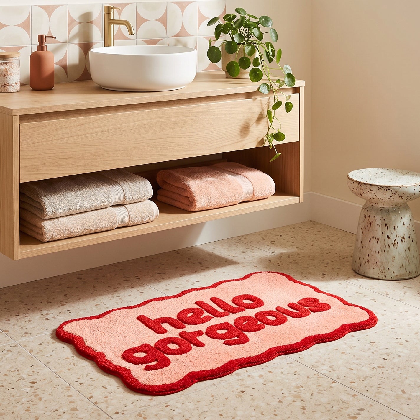 Pink and red bathroom mat with hello gorgeous slogan.