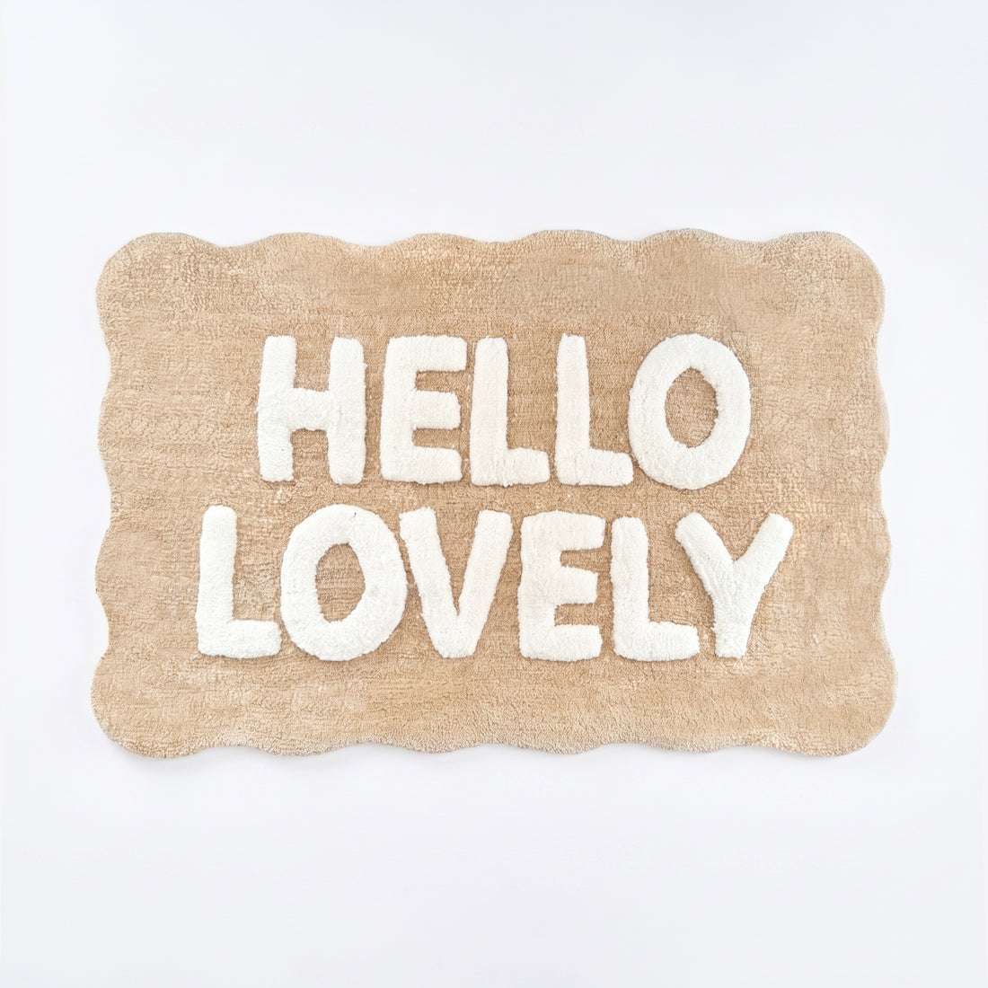 Beige and white scalloped bath mat with hello lovely slogan.