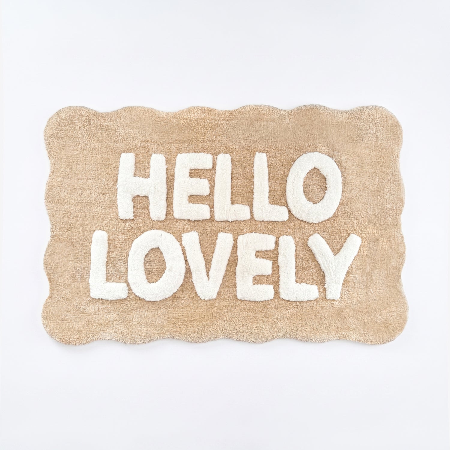 Beige and white scalloped bath mat with hello lovely slogan.